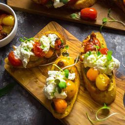 Crostini With Blistered Cherry Tomatoes, Burrata and Chive Oil Recipe